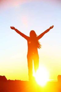 Happy cheering celebrating success woman sunset